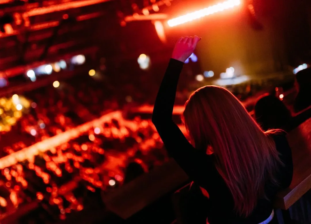 A fan enjoys the music from suite level at The O2 Belfast