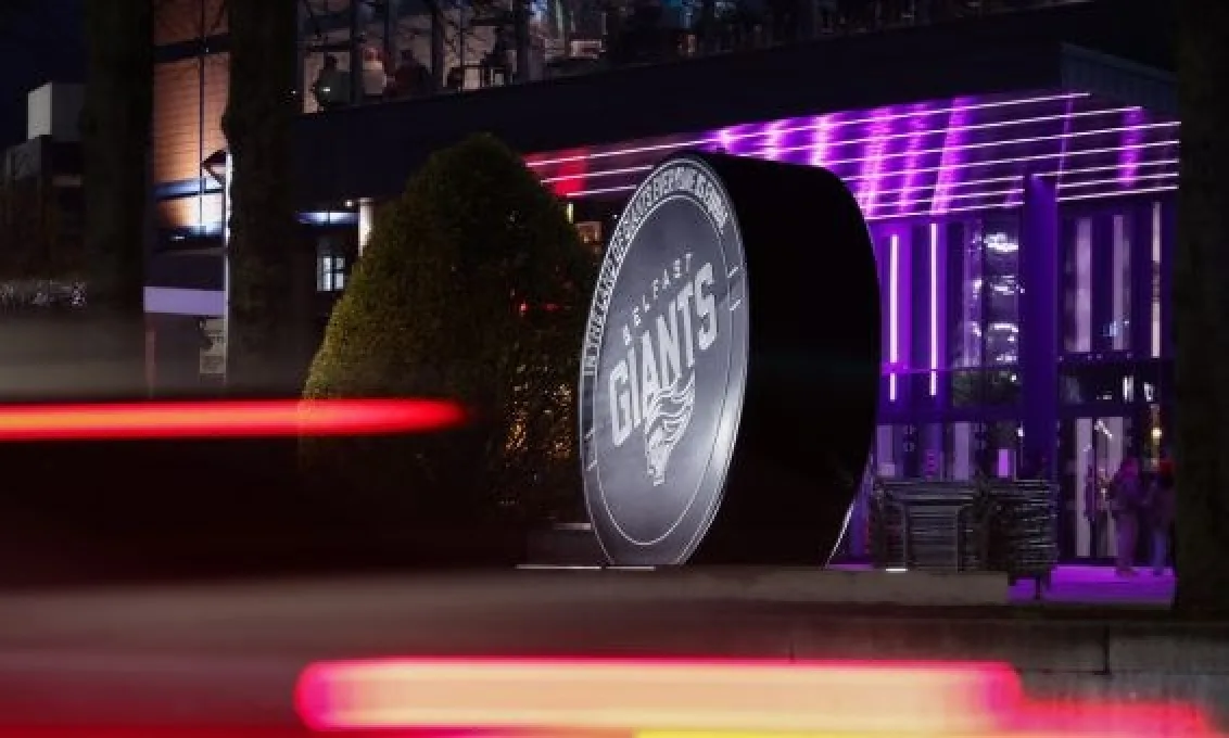 Cars pass The O2 Belfast with a view of the Belfast Giants puck sculpture