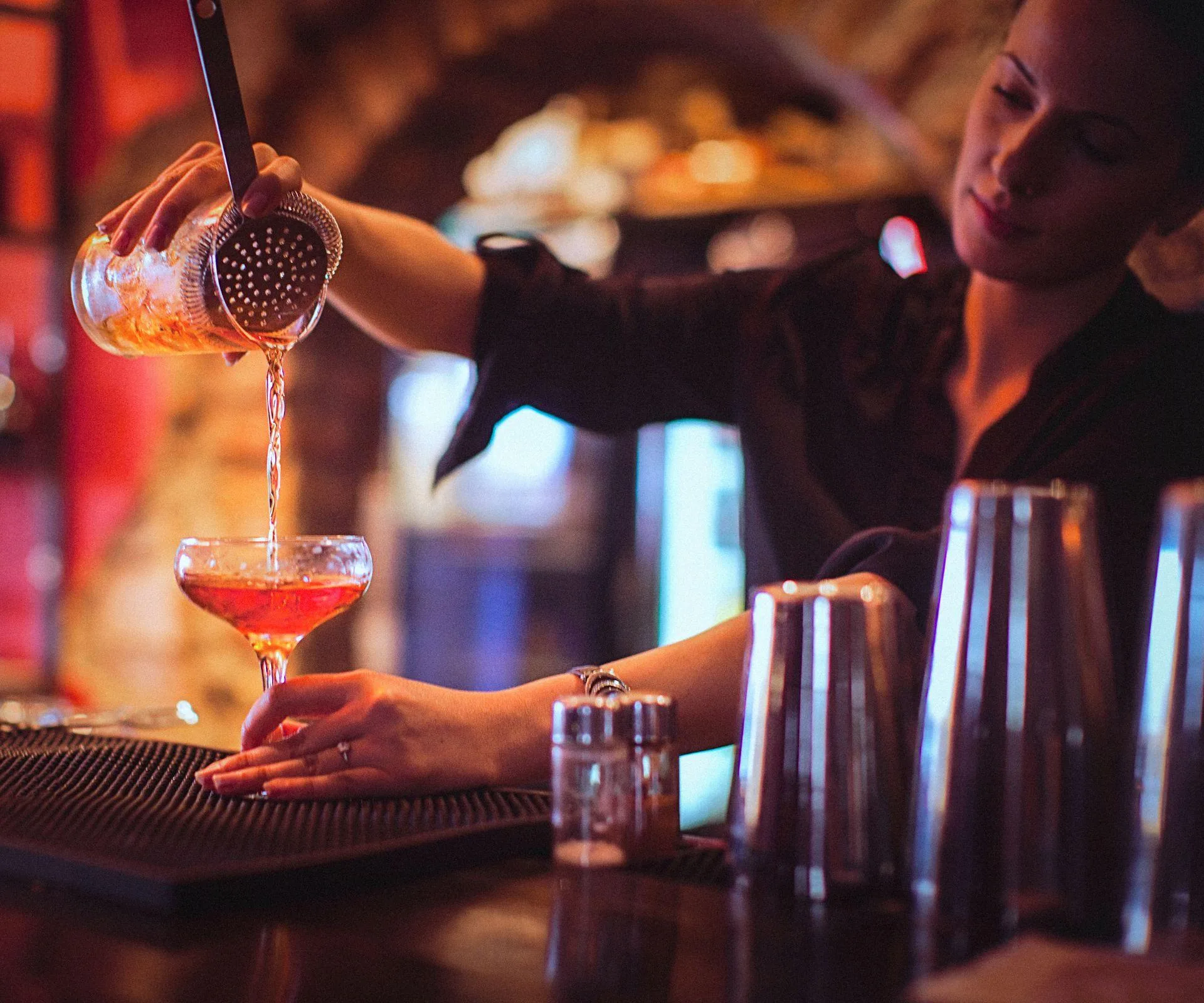 Bartender pours a cocktail